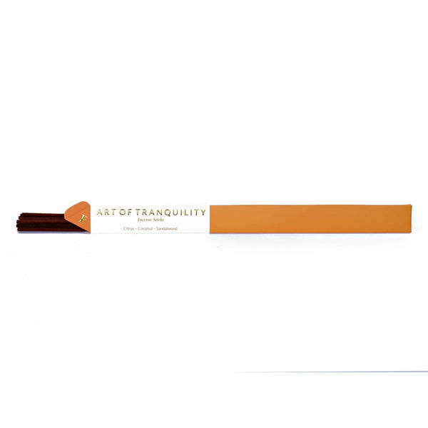 A white background with a package of incense. The package of incense is orange with a strip of white that makes up a third of the packaging. The words "Art of Tranquility Incense Sticks" are written in gold letters before the white packaging. Below it are the words "Citrus, Coconut, and Sandalwood" to describe the fragrance in the incense.  