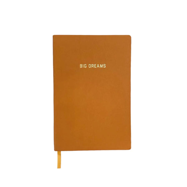A mustard yellow journal with text in golden lettering: "Big Dreams."