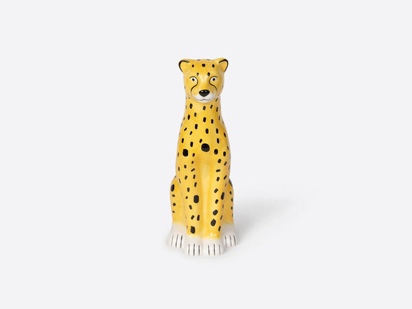 A vase in the shape of a  cheetah sitting before a white background.