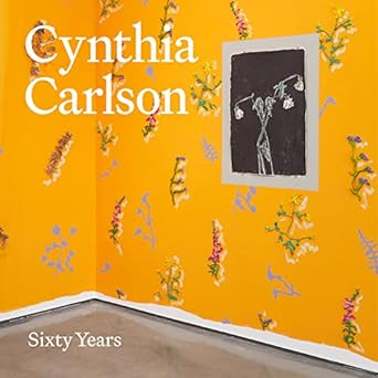 A yellow book cover depicting a wall with a floral wallpaper and text reading "Cynthia Carlson: Sixty Years."
