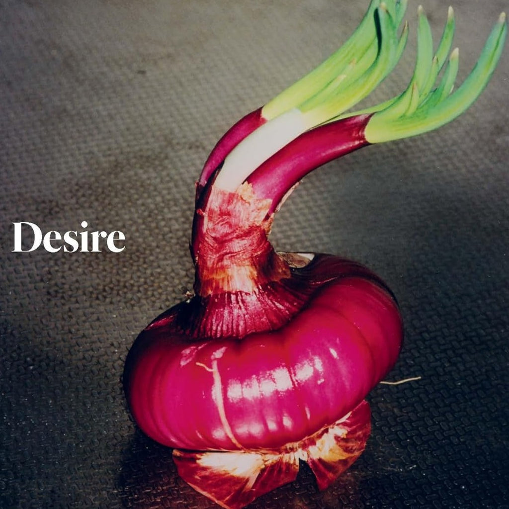 Book cover with a photograph of a sprouting red onion. The title reads "Desire."