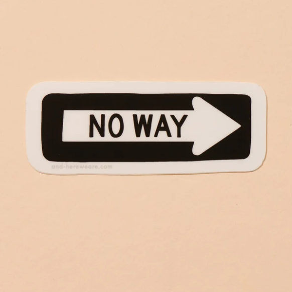 A peachy background with a black sticker before it. The sticker is in the shape of a one way sign with the words "No Way" written on it. 