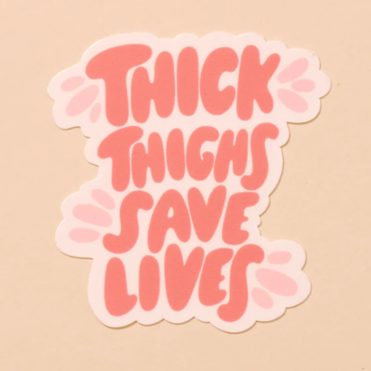 A peach background with a sticker before it. The sticker has the words "Thick Thighs Save Lives" written in coral lettering with pink accents surrounding it. 