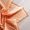 Close-up photograph of a bold, colourful, printed bandana in orange with an abstract floral pattern.