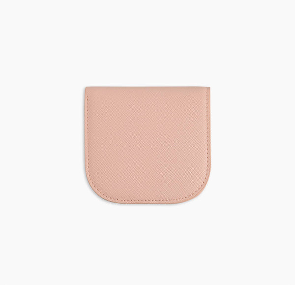 A pink vegan leather wallet before a white background.