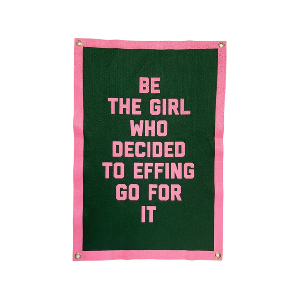 A pink and green wool felt banner with the text "Be the Girl Who Decided to Effing Go For It ."