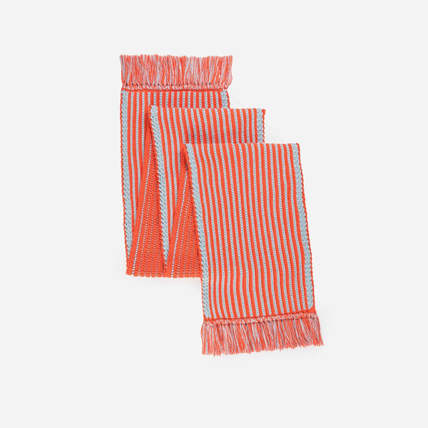 Chunky oversized red and blue knit scarf with playful, graphic rib stripes and contrast fringe.
