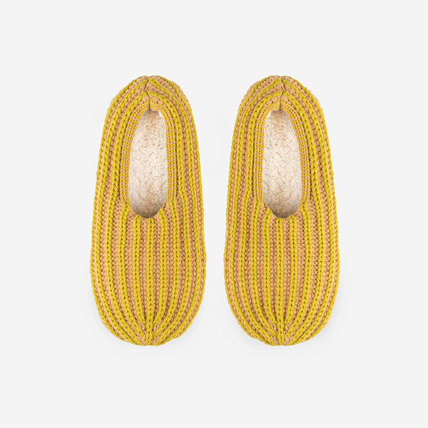 Indoor knit slippers with chunky rib stripes in mustard and beige and fully lined with fleece fabric.
