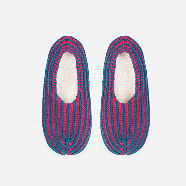 Indoor knit slippers with chunky rib stripes in fuchsia and teal and fully lined with fleece fabric.