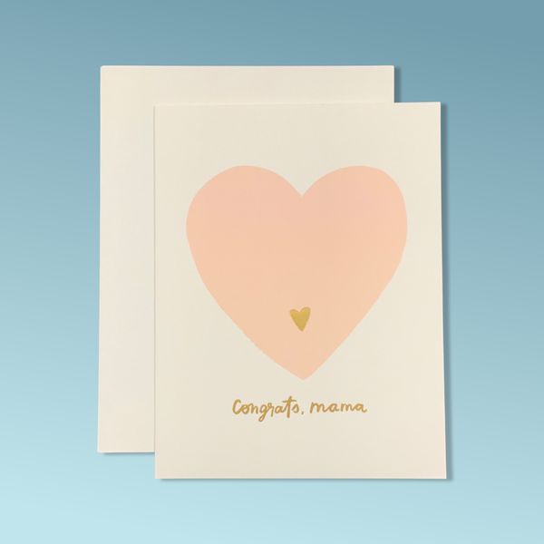 A white greeting card with a pink heart and a small golden heart. The text reads "Congrats, Mama."