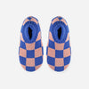 A pair of knit fleece-lined slippers with a checkerboard pattern in pink and blue.