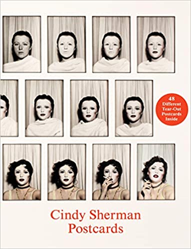 A white box featuring a succession of photographic portraits made in a photo booth showing a woman transform into a movie star. The title reads "Cindy Sherman: Postcards."