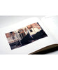 An open book with a photograph of a gondola in Venice.