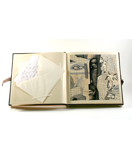 An artist book lying open on a white surface. An envelope is attached to the left page, and a drawing in black and white is on the right.