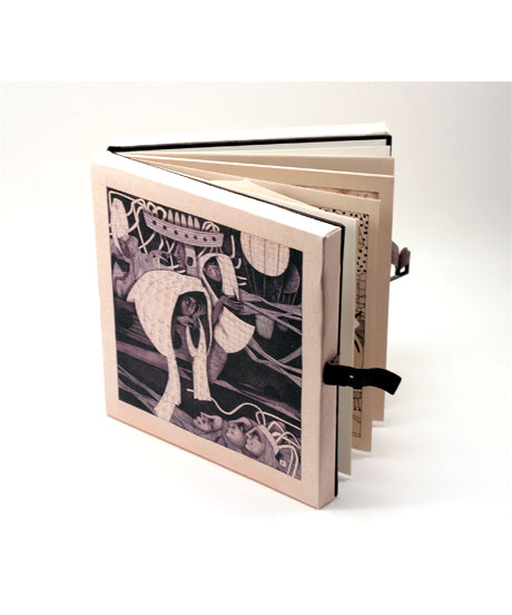 Small artist book with a black and white cover featuring an illustration. Small leather straps are holding the book together.