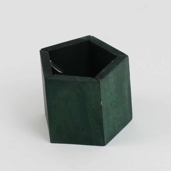 A chunky wooden geometric bracelet in a dark forest green before a white background. 
