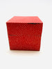 Red note cube with sticky notes with a dot pattern all over.
