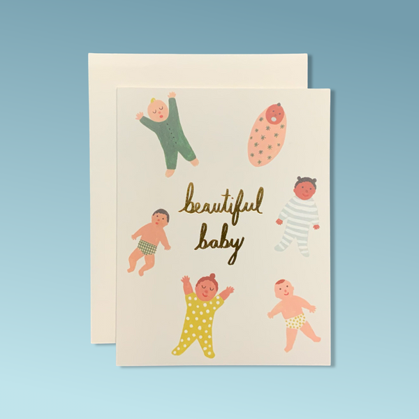 A white greeting card with water color illustrations of babies with different skin tones. The text reads "Beautiful Baby."