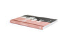 A book is lying on a white surface. The book cover featuring a photograph of a woman with long black hair and a pink brushstroke obscuring half of her face. The title reads "artists on art."