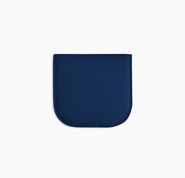 A dark blue vegan leather wallet before a white background.