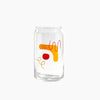 A drinking glass with abstract shapes in red and orange.