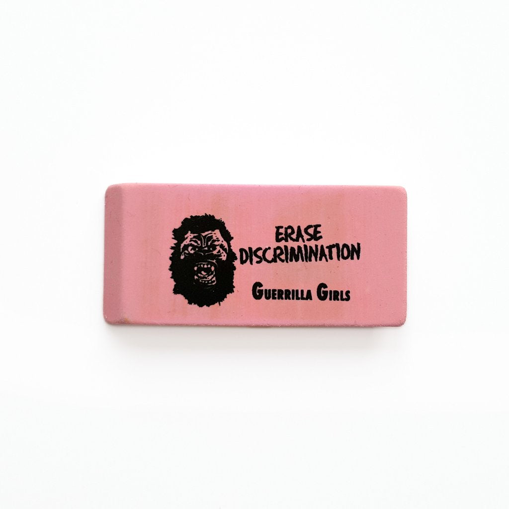Pink eraser with an illustration of a gorilla head and the text "Erase discrimination. Guerilla Girls."