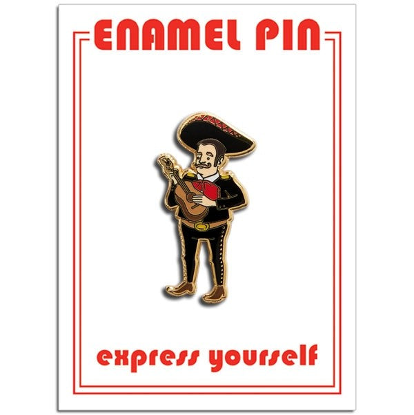 An enamel pin of a man holding a guitar wearing traditional Mexican clothing. In red letters, it says "Enamel pin" and "express yourself".