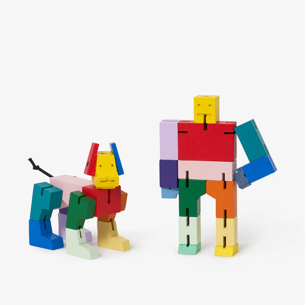 A white background with a robot and a dog made of blocks before it. Each set of blocks is made of multicolored wooden blocks.