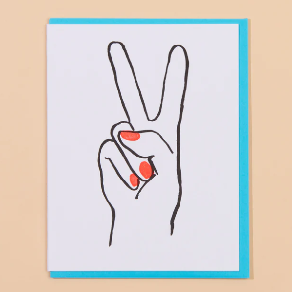 A peachy background with a white card before it. The card features a hand with a peace sign and neon red nails. 