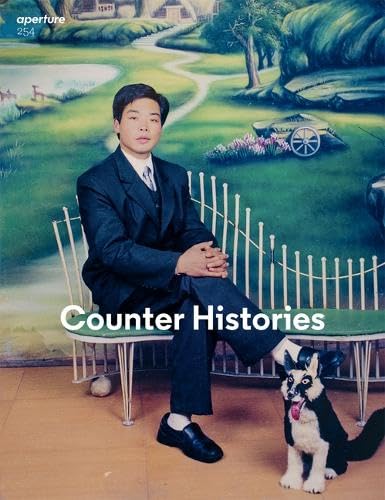 A book cover featuring a photograph of a man sitting next to a dog in front of a painted landscape. The text reads "Counter Histories."
