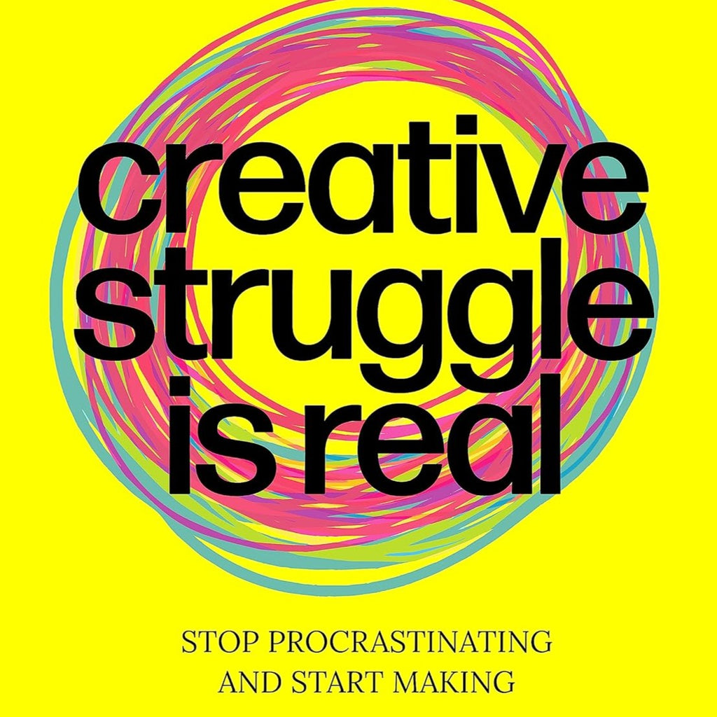 A yellow book with the an artistic circle design and the words "Creative Struggle is Real."
