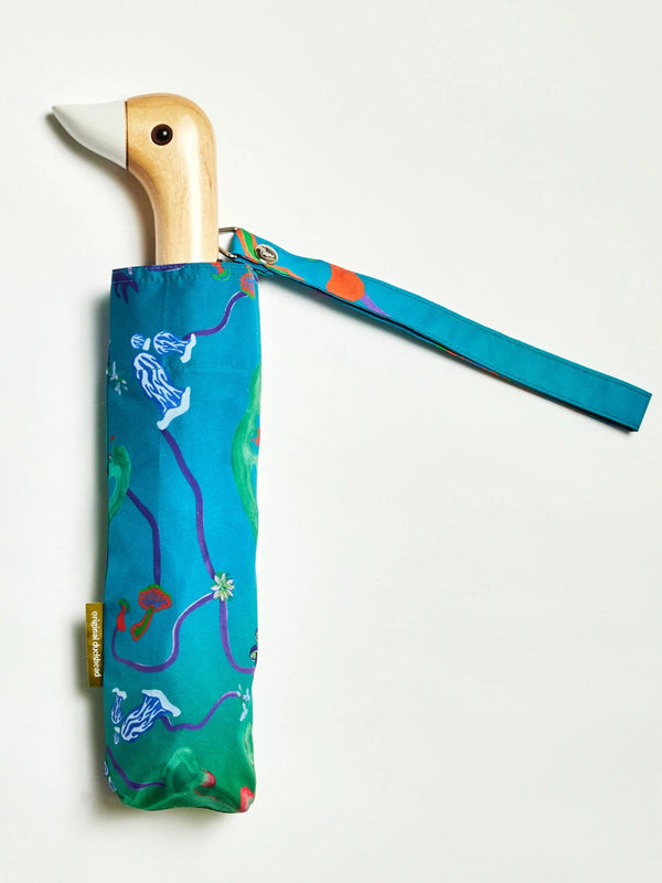 Umbrella in a teal color with a wooden duck's head for a handle.