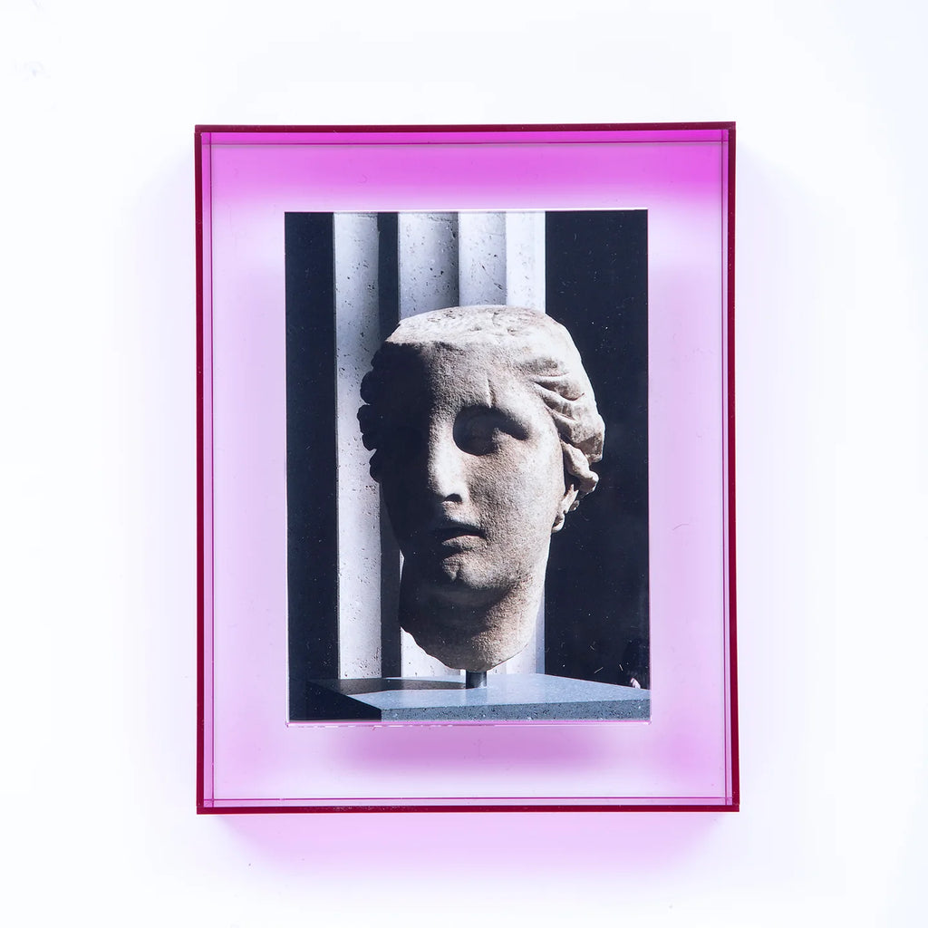 Print of a marble sculpture within a neon pink frame.