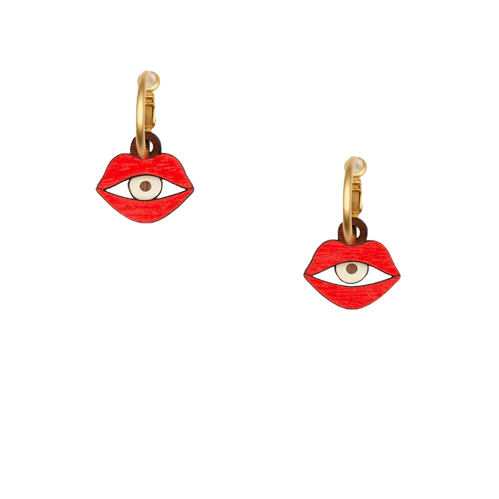 Golden hoop earrings with a lip pendant. An eye is in each lip.