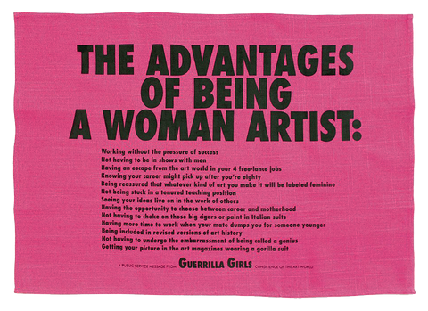 A pink tea towel with text that reads: "The Advantages of Being a Woman Artist." There is more detailed text underneath. 