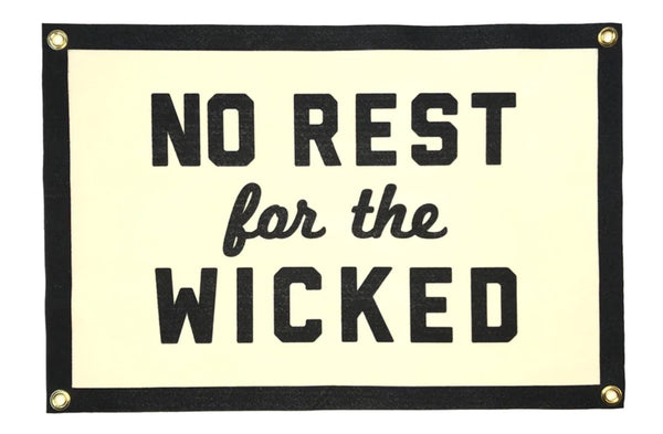 A white background with a black and white banner in the foreground. The banner is white with a black border. It features the words "No Rest For the Wicked" with the words "For The" in cursive writing. 
