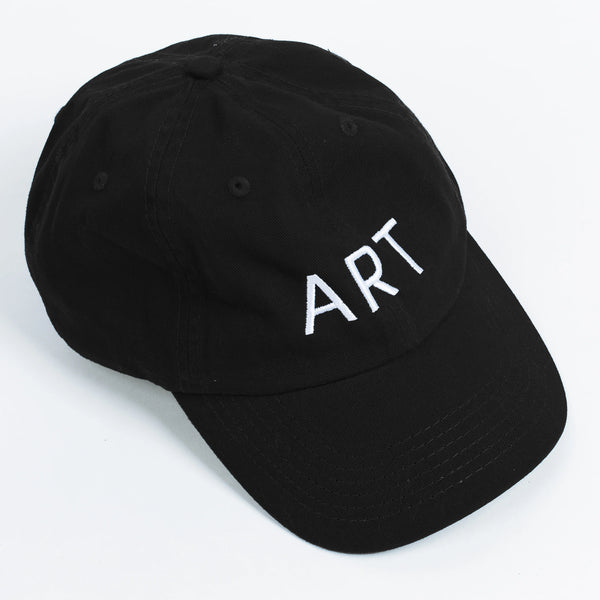 A black baseball cap with the word "ART" written in white, capital letters across the front. 