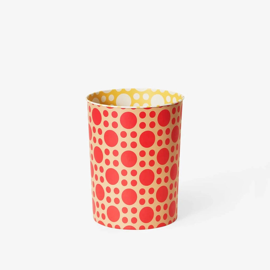 A white background with a trash can before it. The trash can is yellow on the outside with various sizes of red polka dots dotting it. The interior of the trash can is yellow with white polka dots dotting it. 