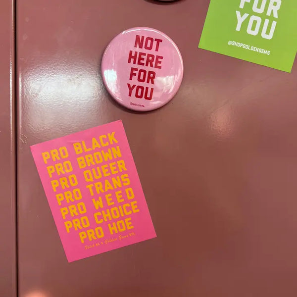 A pink locker with a pink sticker before it. The sticker reads "Pro Black Pro Brown Pro Queer Pro Tans Pro Weed Pro Choice Pro Hoe."