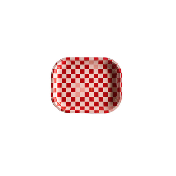 A white background with a tray before it. The tray is checkered with red and pink squares. 
