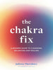 A white book with a rainbow gradient in the middle. The title "The Chakra Fix" is in large, white letters in the foreground. Below the title are the words "A Modern Guide to Cleansing, Balancing and Healing."