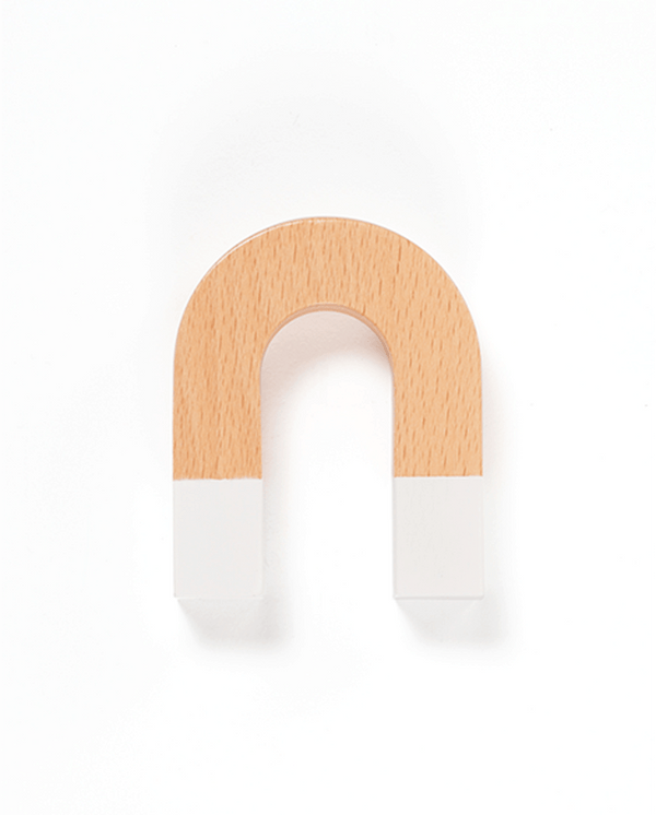 A white background with a horseshoe shaped magnet before it. The magnet features white magnets and a wooden handle. 