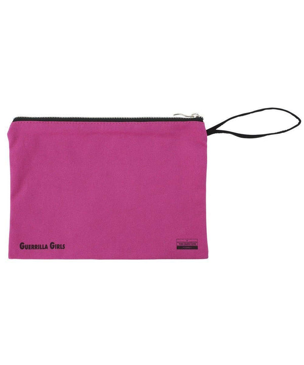Back side of a pink clutch with a black zipper and text that reads: "Guerilla Girls" on the bottom.