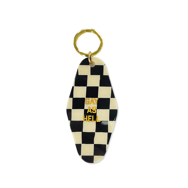 A white background with a keytag before it. The keytag features a pattern of black and white checkers and the words "Gay As Hell" in gold letters.