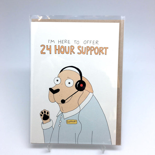 A greeting card depicting a dog with a headset holding up his paw. The dog has a sticker on the shirt saying "support." The title on the card says: "I'm here to offer 24 hour support."