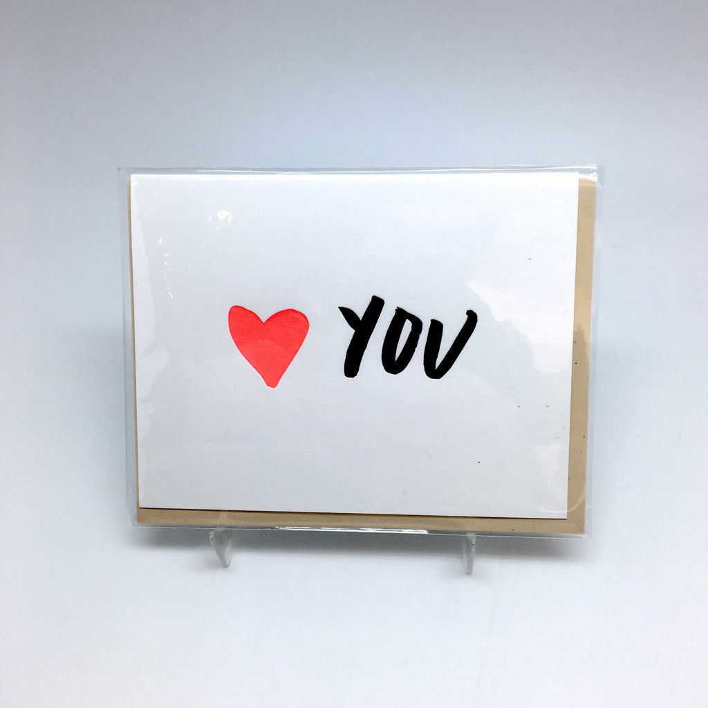 A white background with a white card before it. The card features a red heart and the word "You." 