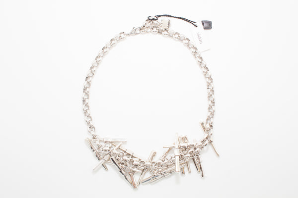 A silver-plated necklace with a chunky chain and several pendants in the shape of rectangles attached to the chain.