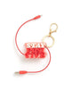 A keychain with text in white and red capital letters that read "Stay positive"