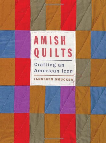 A colorful book cover with a photograph of a quilt. In red and blue letters, the title reads: "Amish Quilts: Crafting an American Icon."