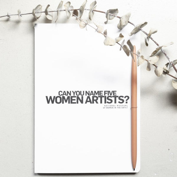 A white notebook with large black letters that read "Can you name five women artists?"